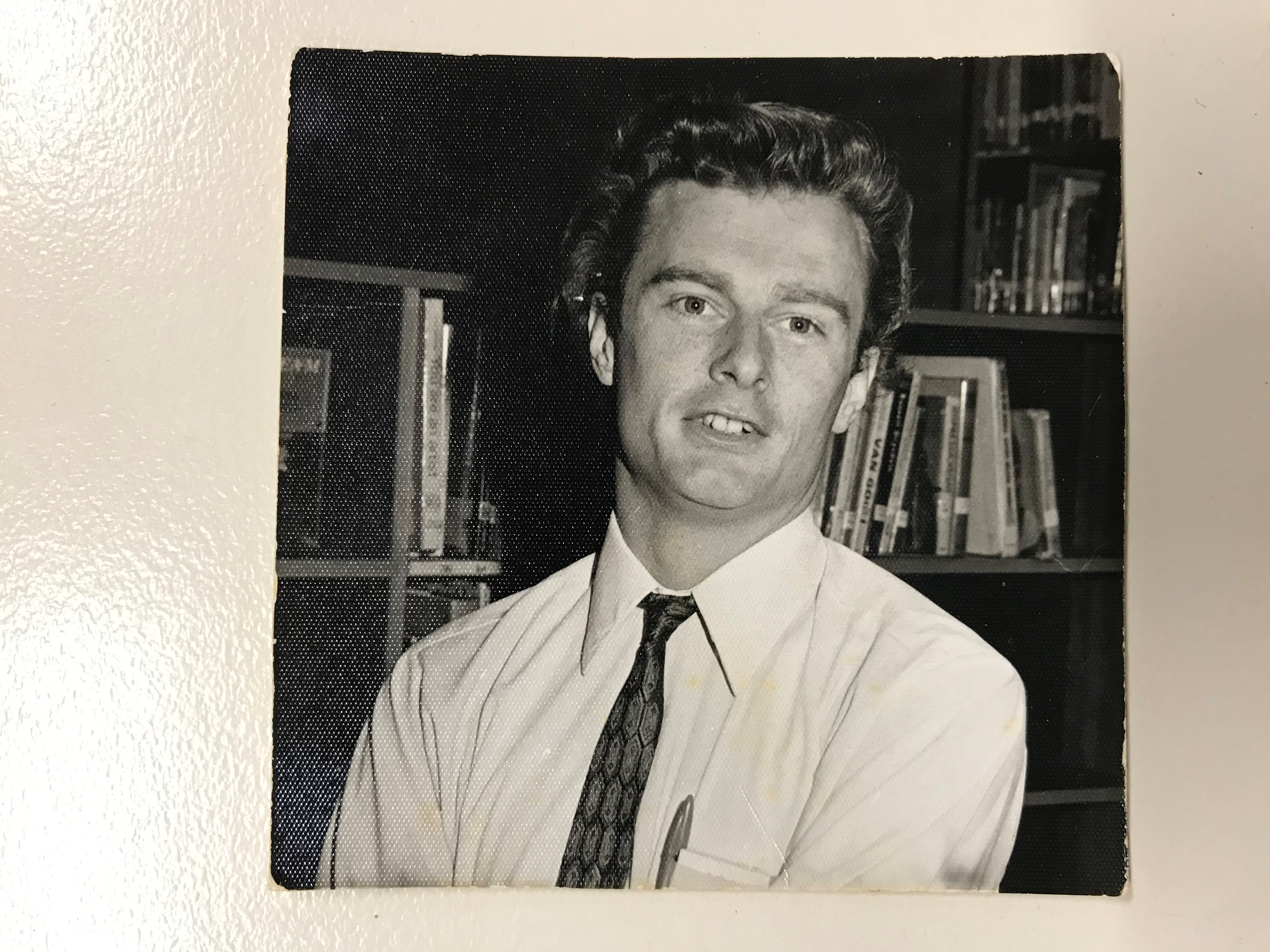 A young David Waterhouse smiles in an old, sepia printed photo.