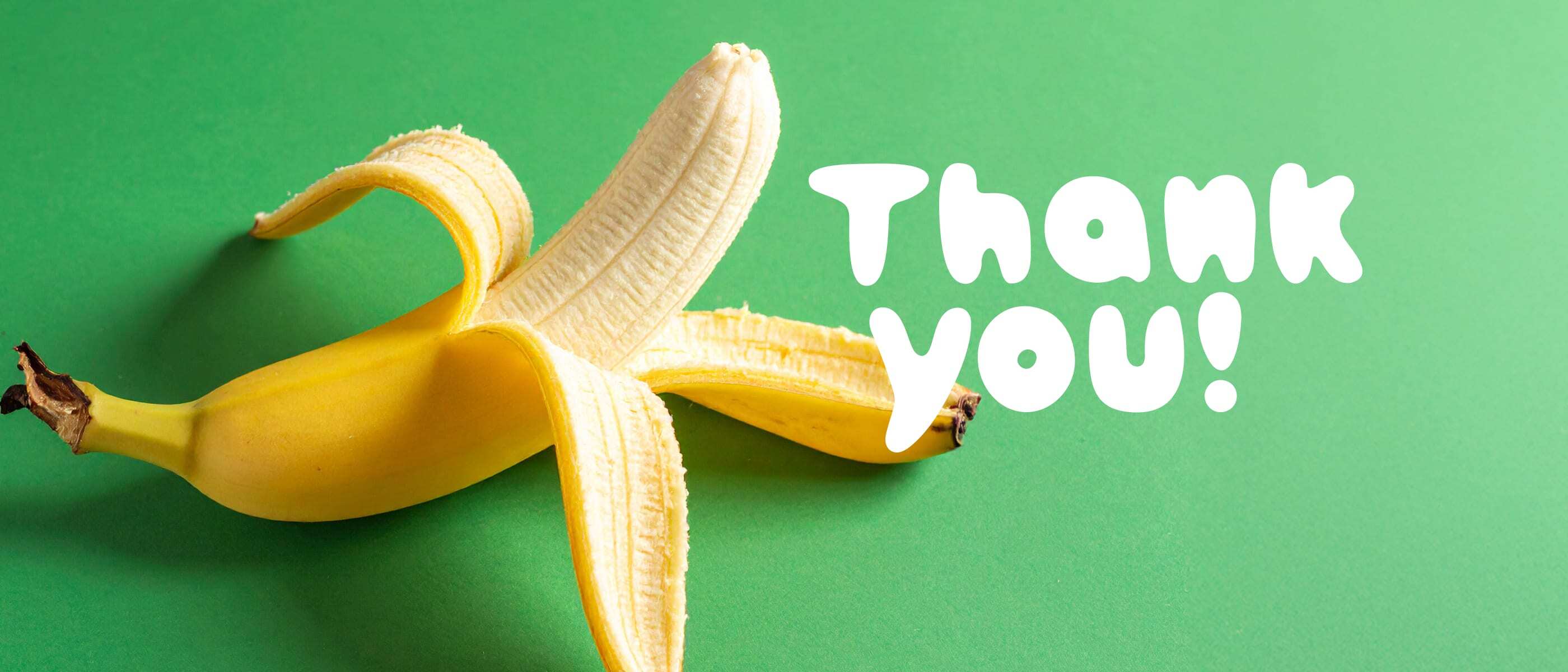 Plastic Free July landscape banner image with a banana peeling against a green background with text overlay, "Thank you"