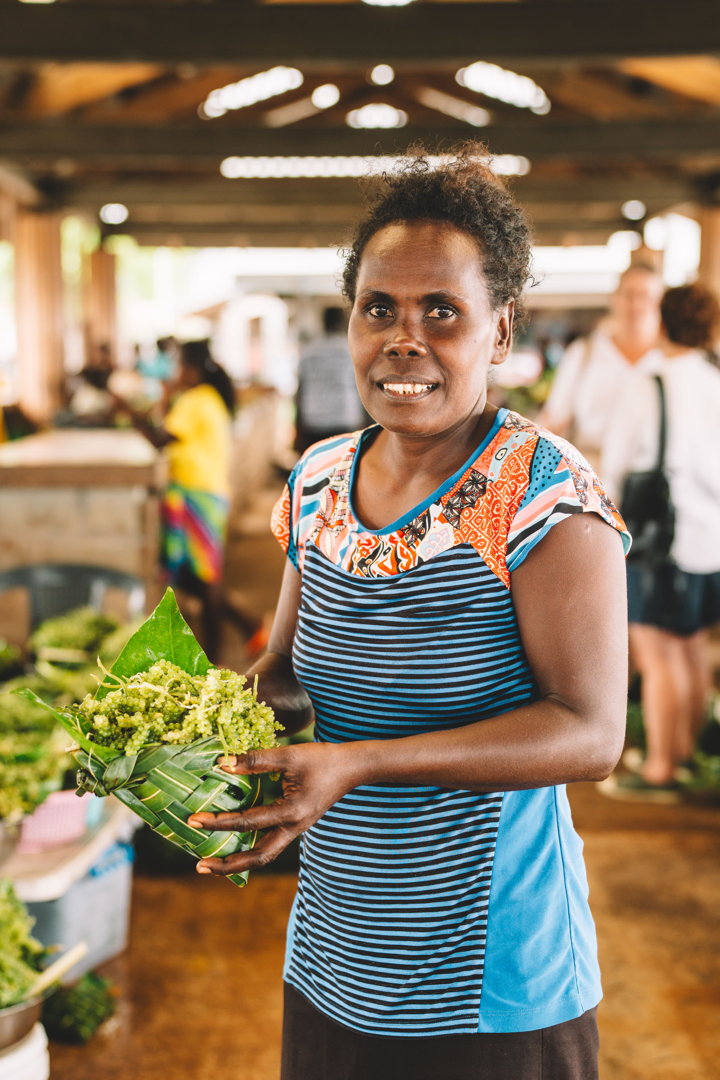 Nerolyn, a community facilitator, selling sea grapes at the local market.
