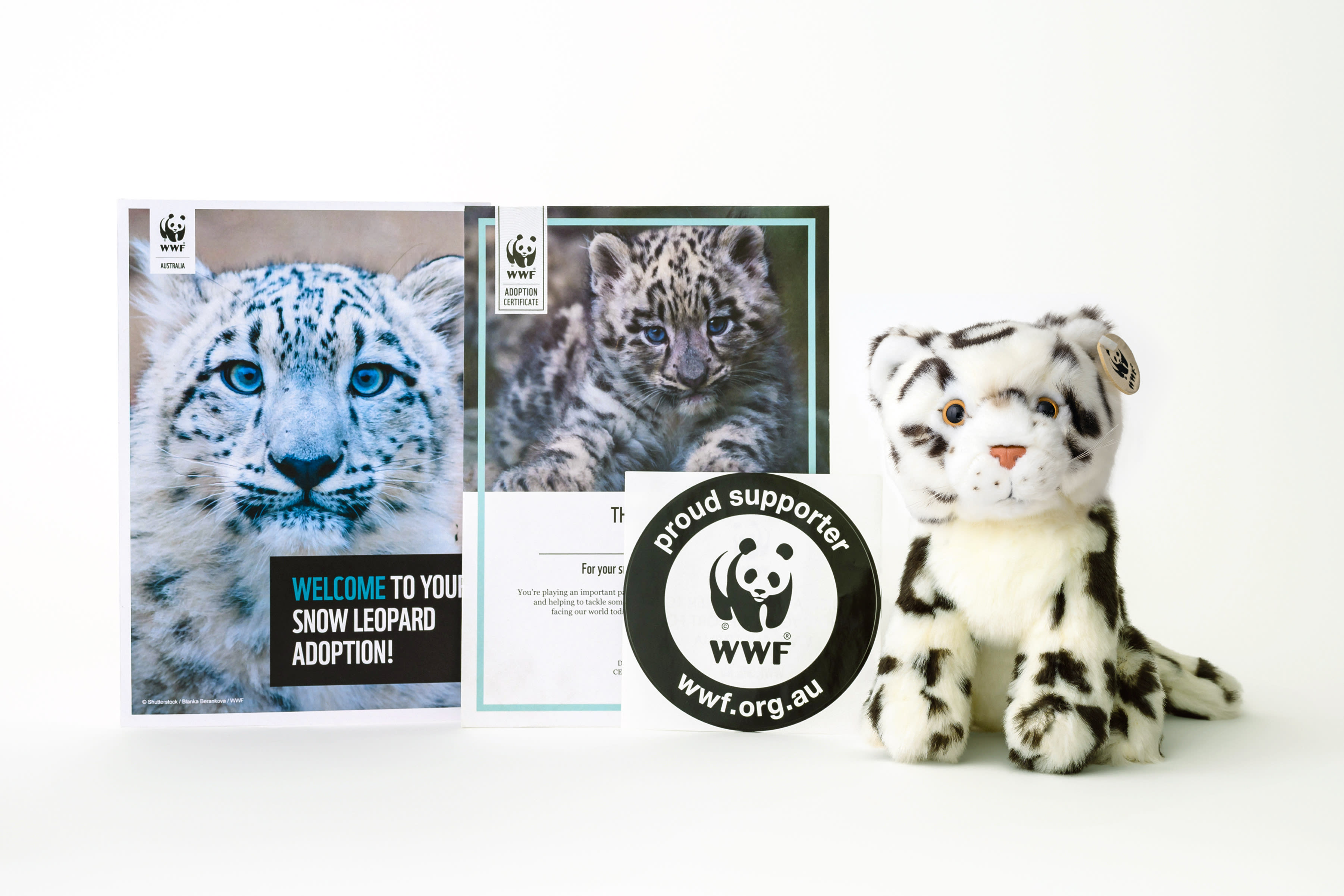Contents of snow leopard adoption pack, including snow leopard plushie, adoption certificate and snow leopard booklet