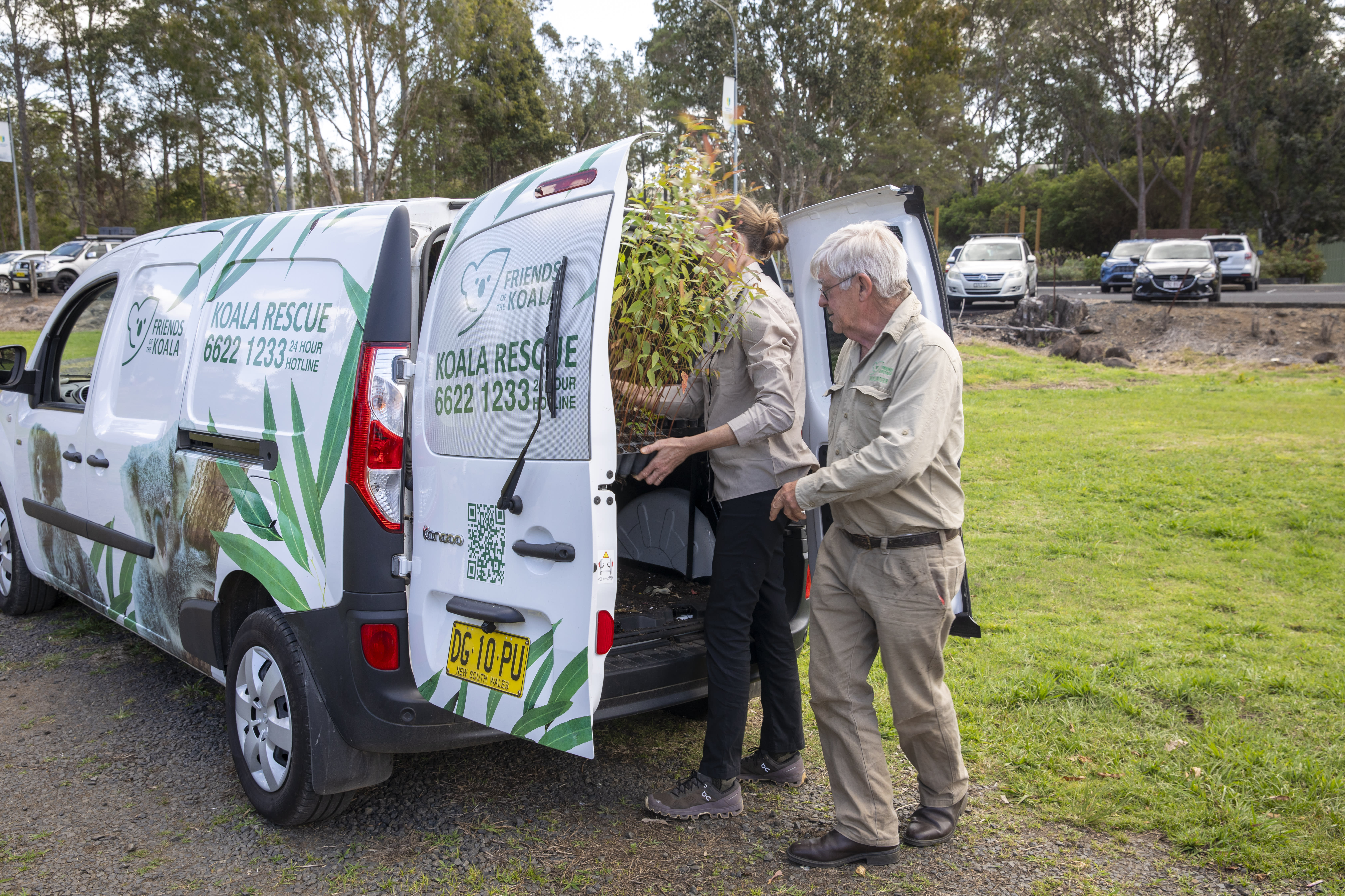 WWF-Australia's Tanya Pritchard and Friends of the Koala nursery volunteer Peter Cassidy load seedlings into the new electric van