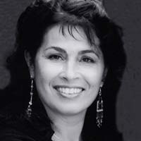 Black and white headshot of woman smiling at camera