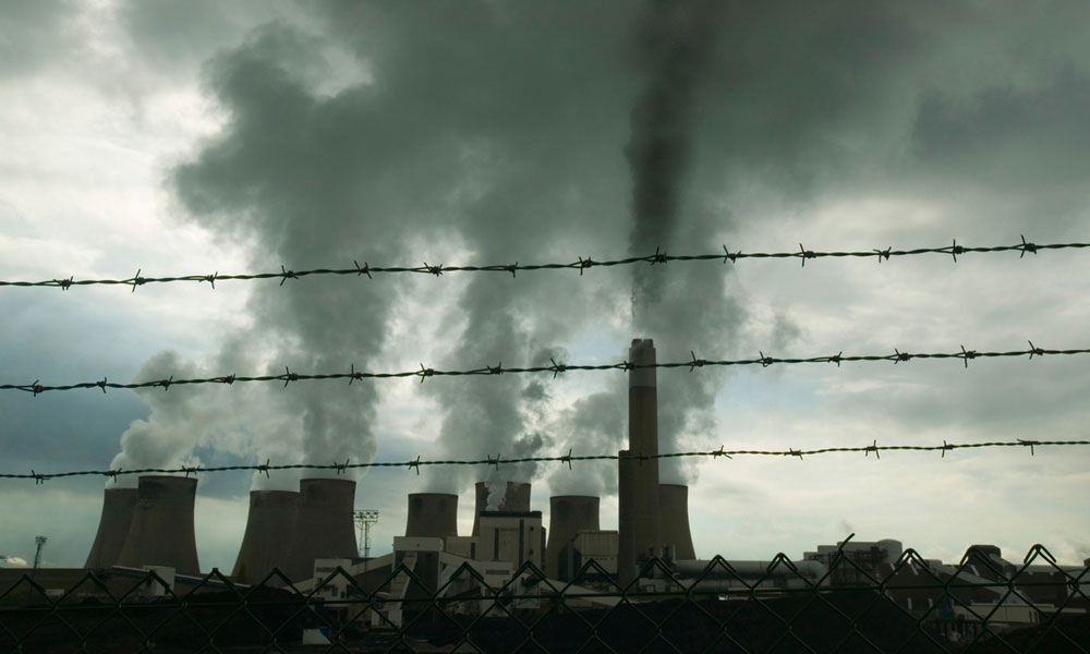 A large coal power station in the UK with barbed wire in the foreground