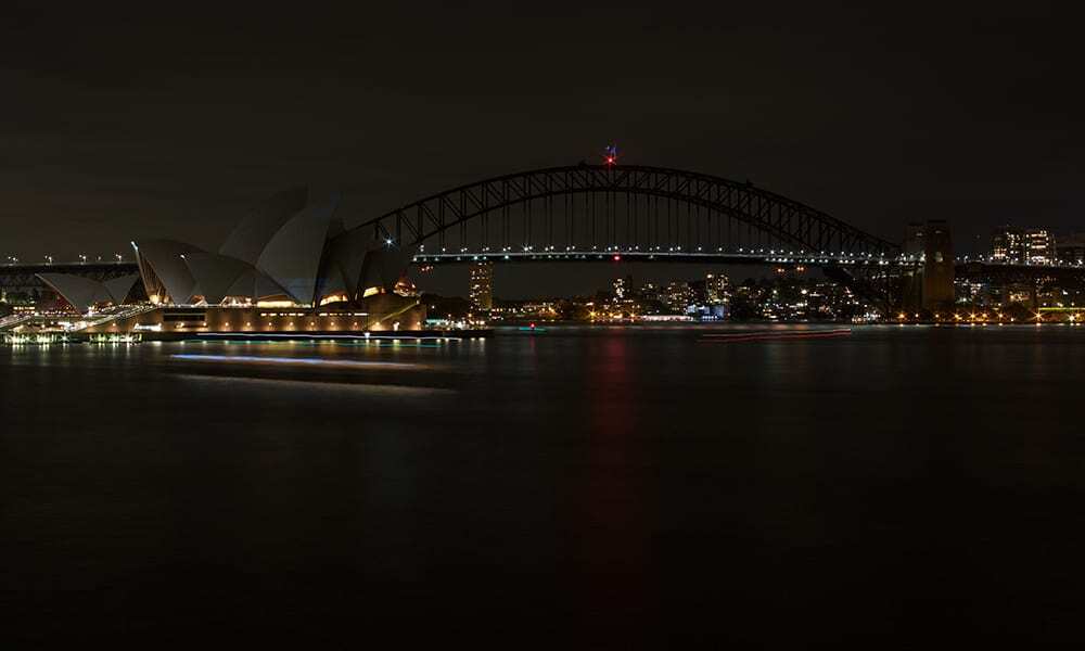 Sydney Harbour Bridge and the Opera House with lights off for Earth Hour 2017