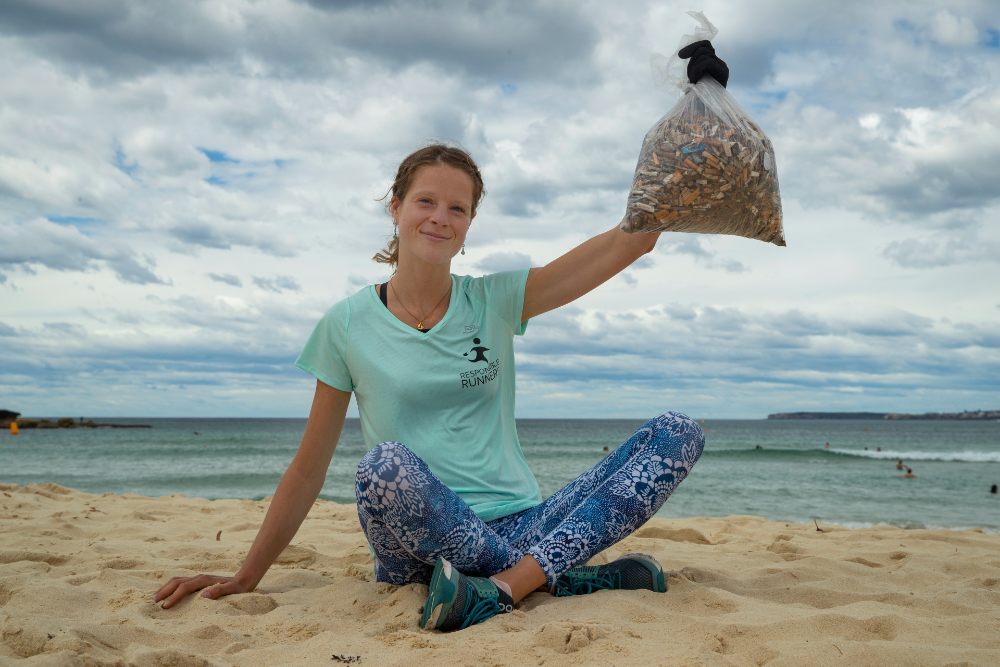 Mylene Turban= Responsible Runners Coordinator is holding up more than 3=000 cigarette butts collected from Bondi and Bronte since last year