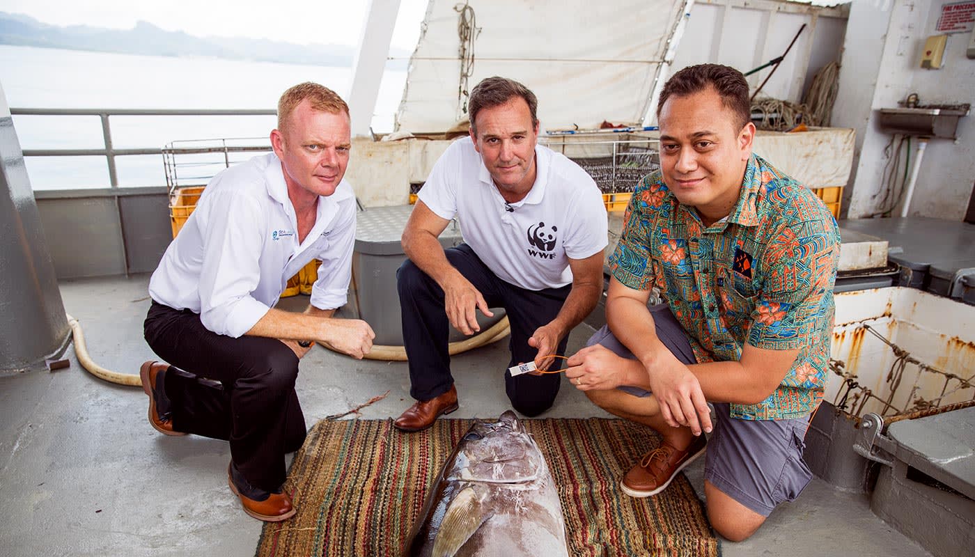 Brett Heywood, SeaQuest Fiji CEO, Dermot O'Gorman WWF-Australia CEO and Ken Katafono, TraSeable Solutions CEO next to a yellowfin tuna about to be tagged with QR code