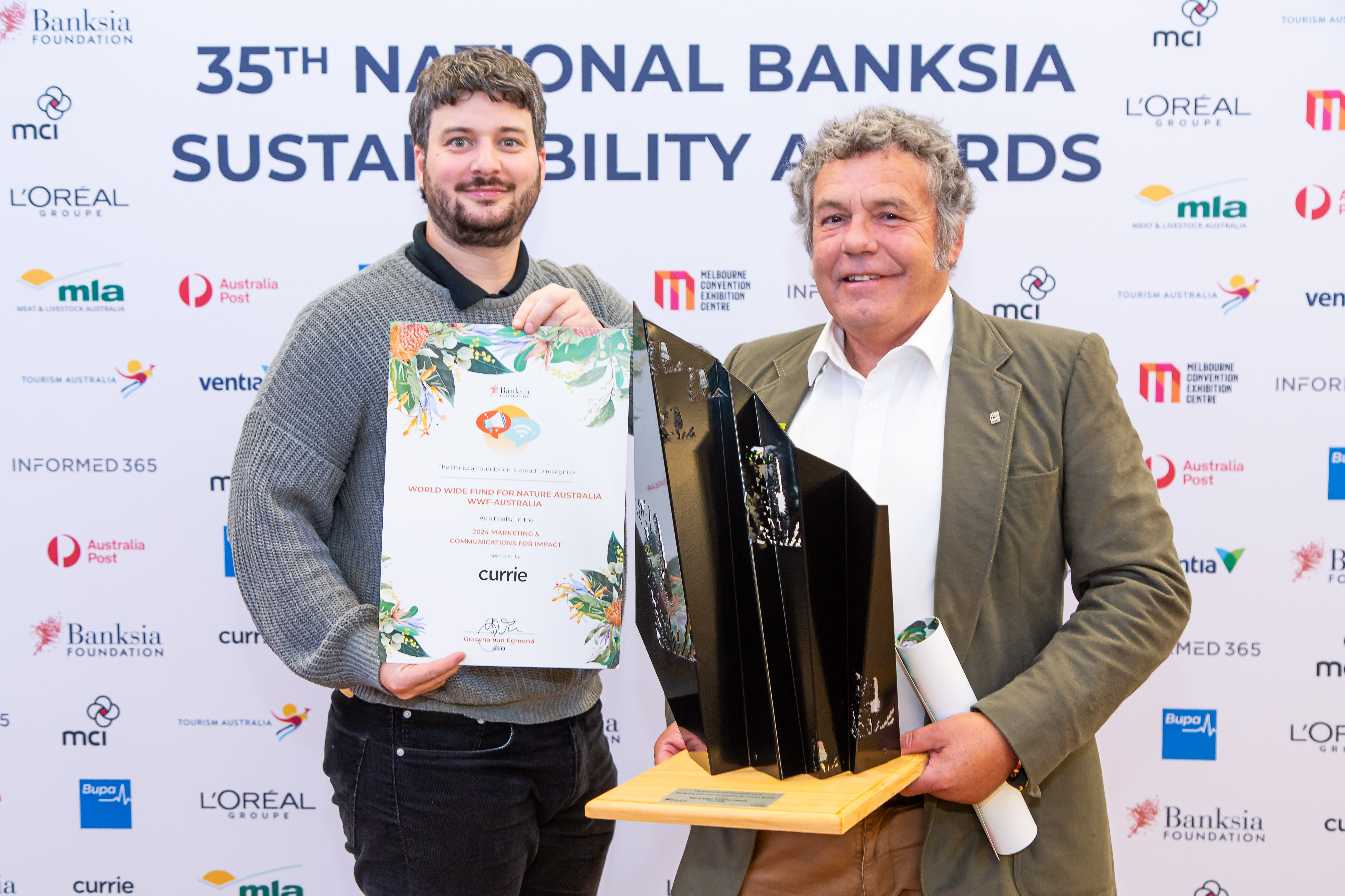 Darren Grover and Djarra Delaney accept the Banksia Award for Marketing and Communications for Impact Award for the Net Free Reef campaign at the Banksia Awards 2024