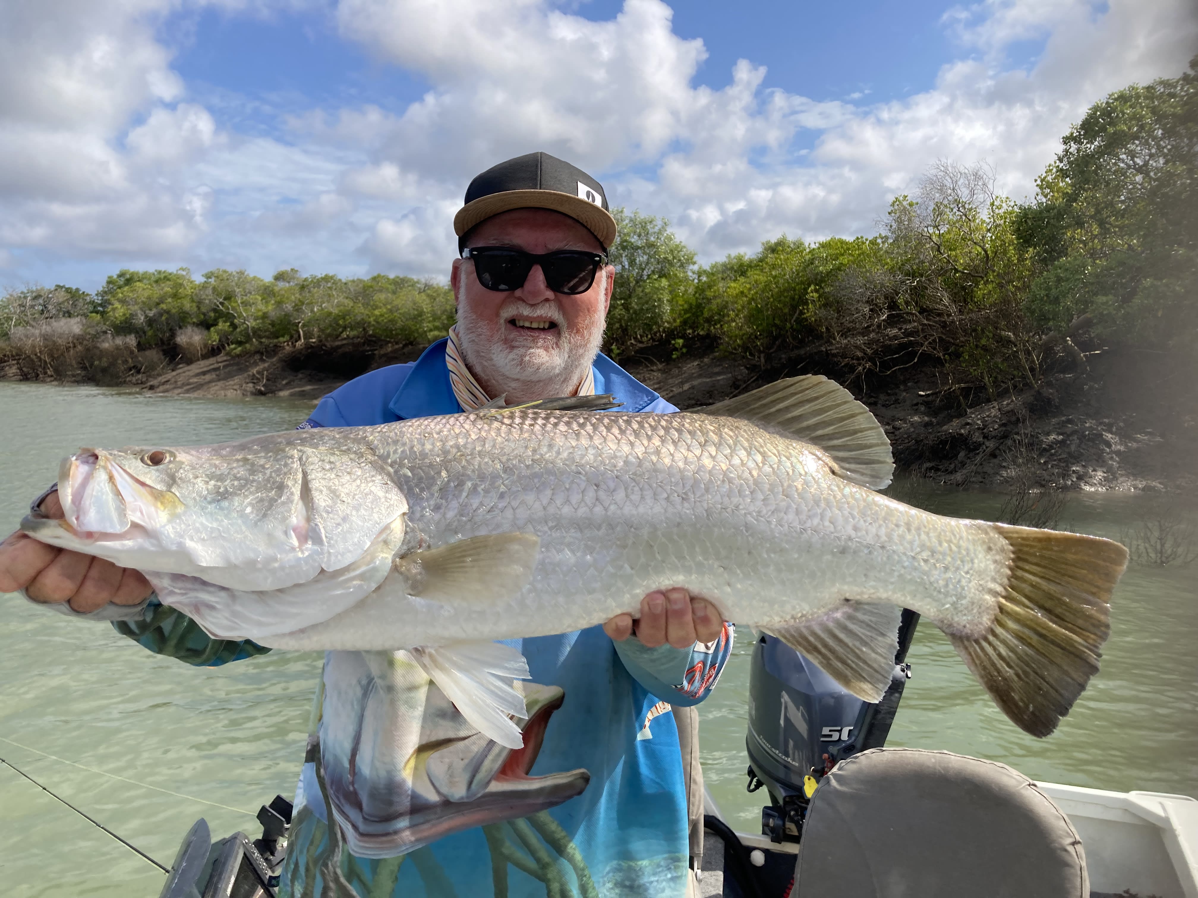 Recreational fisher Michael Powell holding up a barramundi in Rockhamption